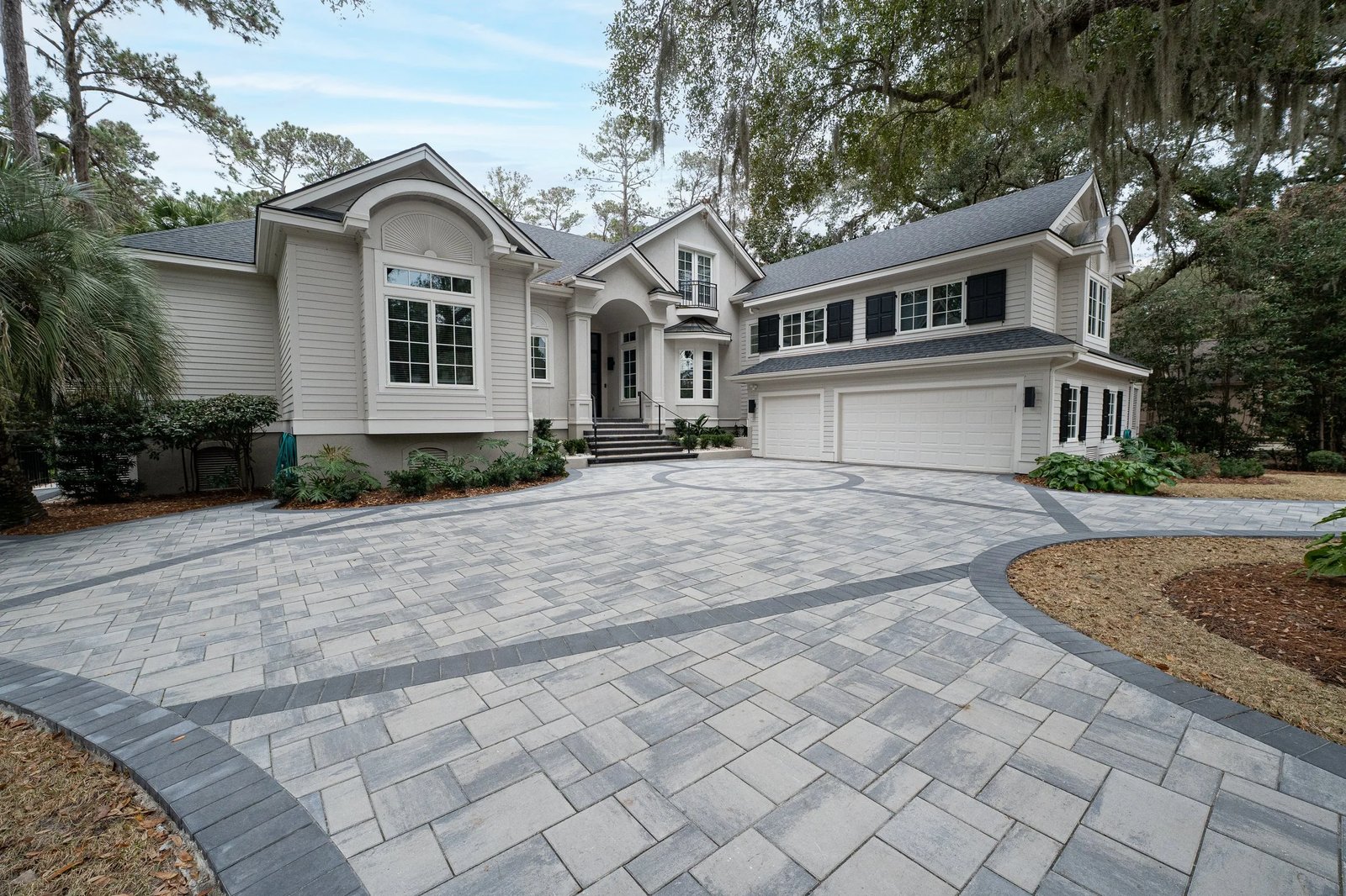 Paver driveway and walkway leading to a home