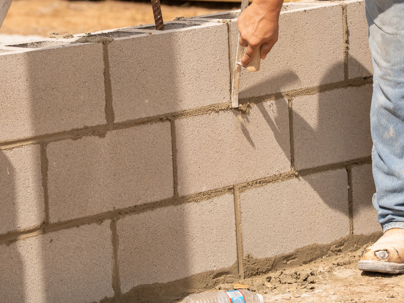 Tooling the mortar joints on a concrete block wall