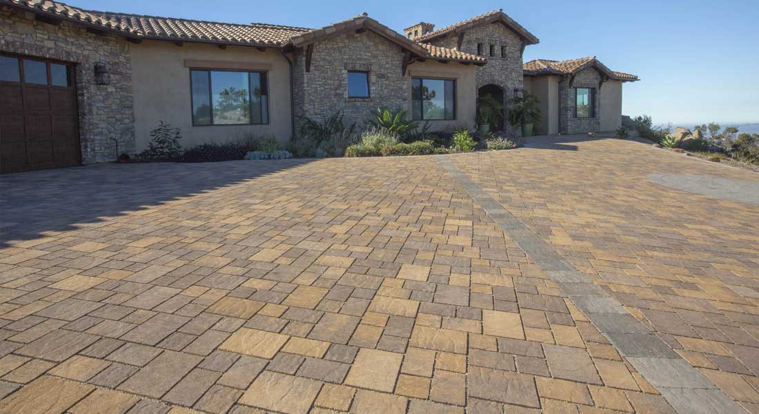 Paver walkway leading to Mediterranean-style entry