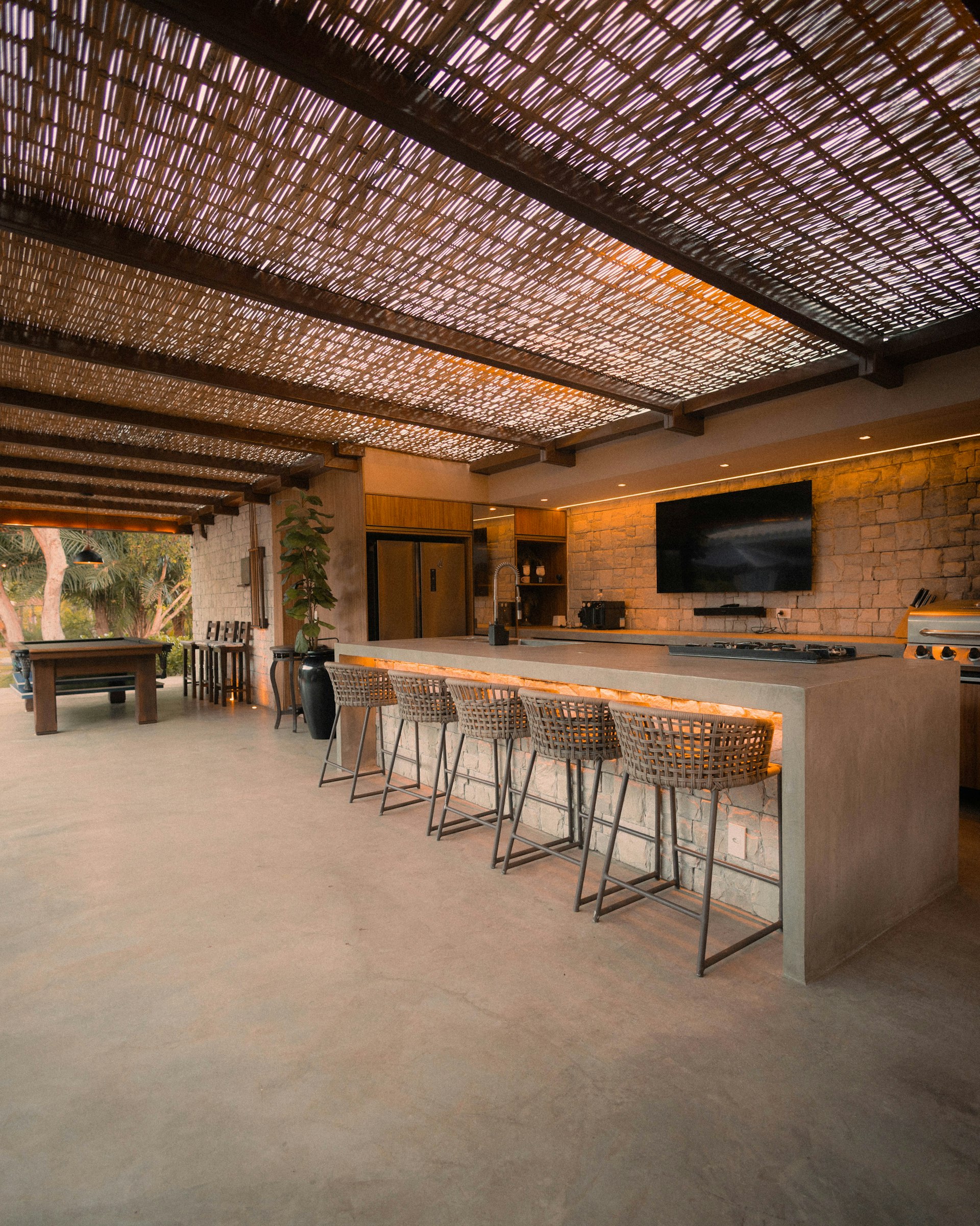 Custom stone outdoor kitchen and bar by Coronado Exteriors
