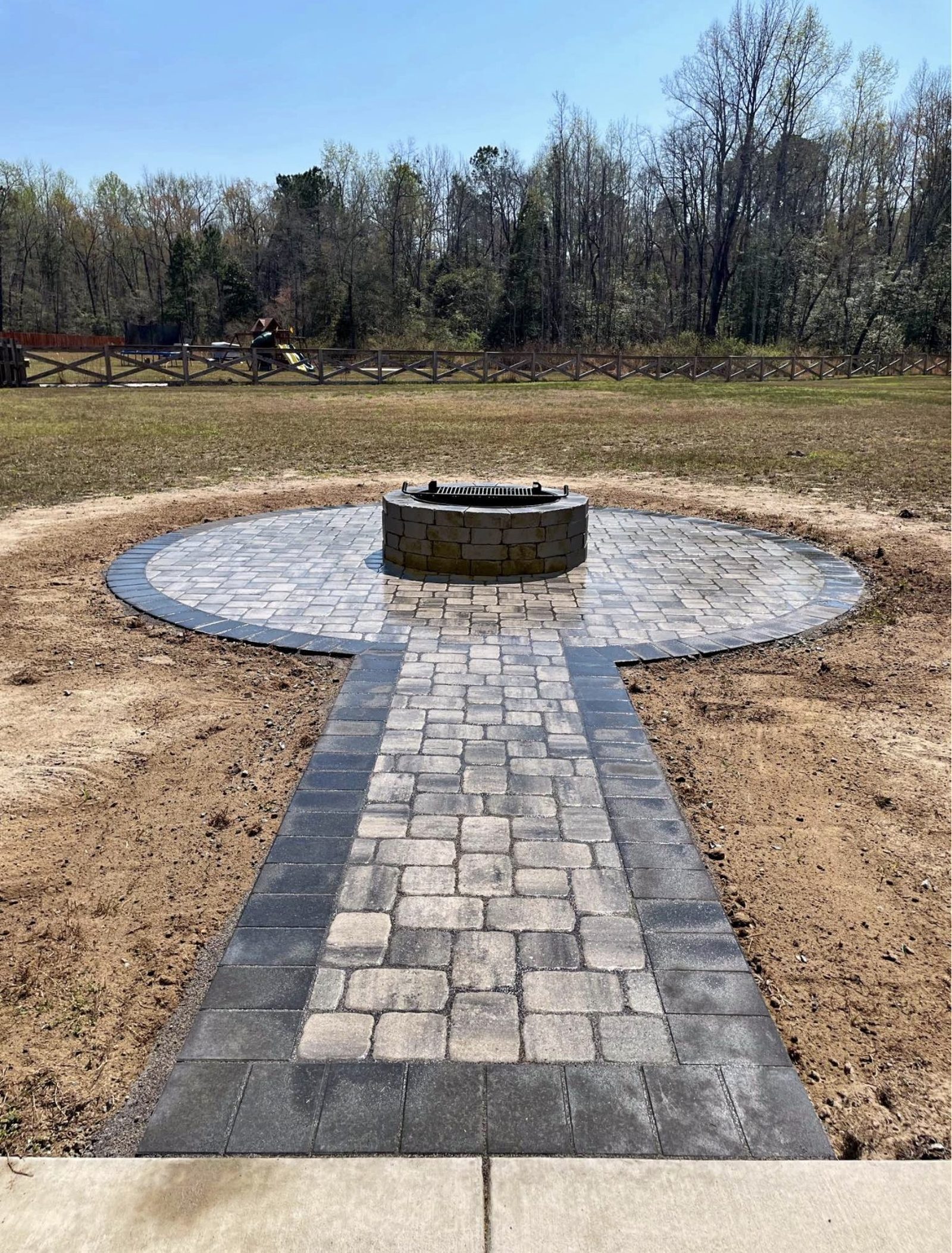 Custom fire pit and paver walkway by Coronado Exteriors