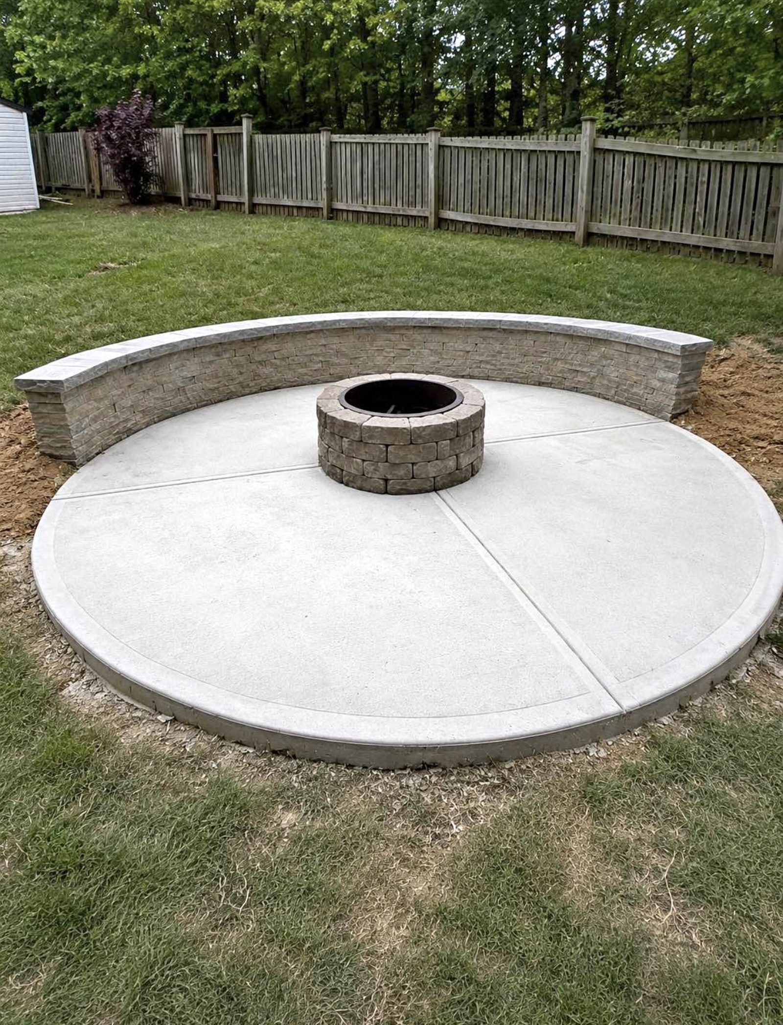 Custom paver fire pit with seat wall by Coronado Exteriors