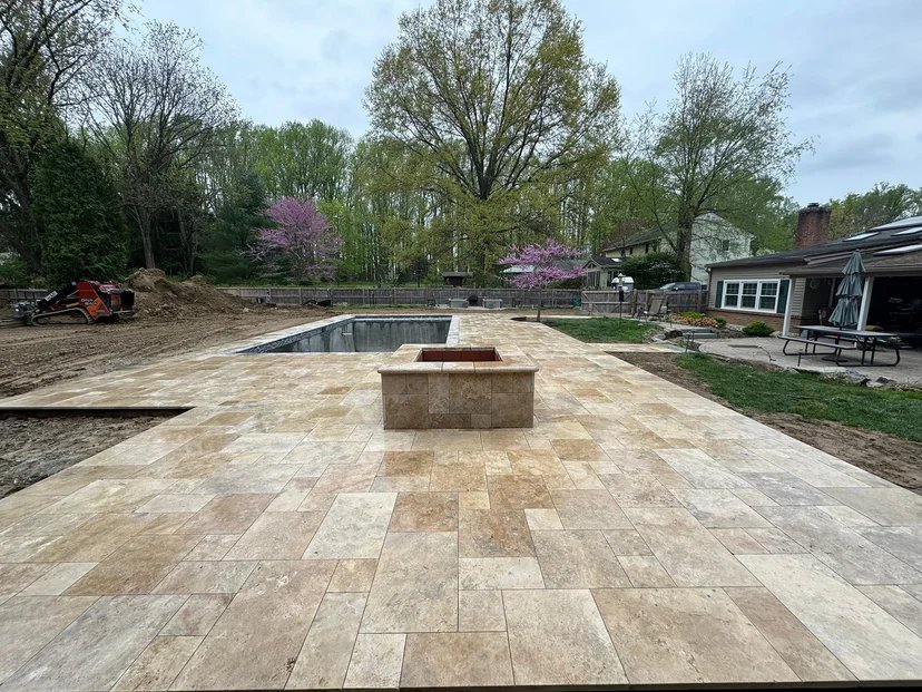 Travertine paver driveway surface beside garage